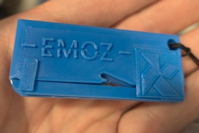 3D-printed paper cutter (with EMOZ logo), a replacement for the original envelopener