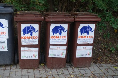 Origami-styled elephant logo of Kom-Eko company displayed on trash cans