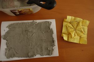 Plaster with a fresh impression, with original origami model (Tumbling Square Rosette)