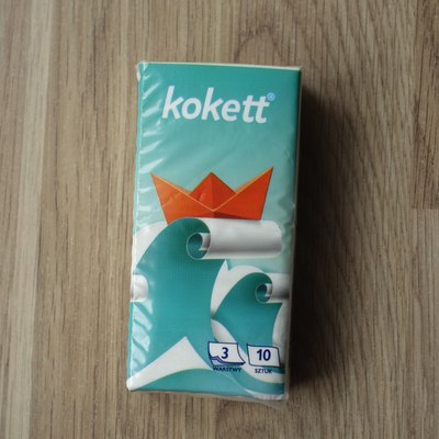 Package of tissues (paper handkerchief) with origami boat motif