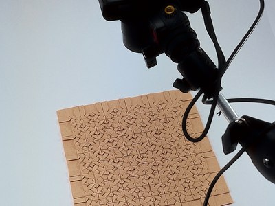 Robot arm above an origami tessellation