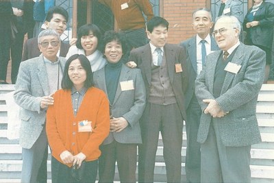 Picture from 10th CDO origami convention in Verona, 1988. Left to right: Fumiaki Fujita, Eiki Momotani, Tomoko Fuse, Eriko Momotani, Kunihiko Kasahara, Shuzo Fujimoto (brown suit), Hisashi Abe, Vicente Palacios. Image by M.A. Palacios. Scanned from NOA Magazine 166 (6/1989), provided courtesy of Hitoshi Fujimoto.