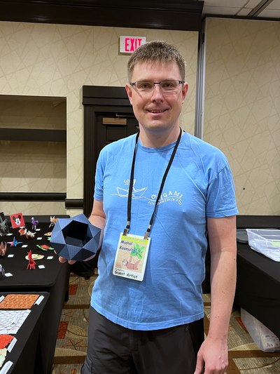 Michał Kosmulski at CenterFold 2024, holding his Geometric Vase origami model. Image by Kay Eng.