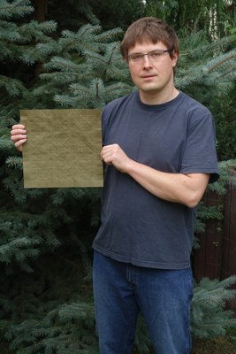 Michał Kosmulski, holding a precreased sheet of paper